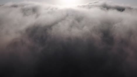 Aerial-rising-view,-up-through-thick-rain-storm-cloud