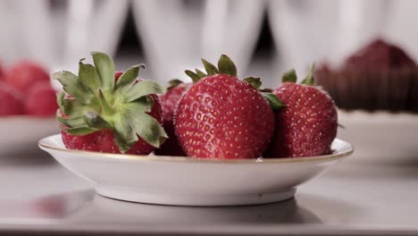 camera-reveals-tasty-strawberry-on-a-plate-with-dolly-movement-on-the-kitchen-table-close-up-shoot