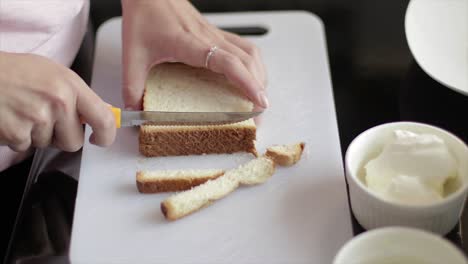 Cutting-the-crust-out-of-bread-slices