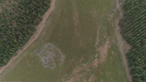A-man-made-structure-with-rocks-as-the-main-material-forming-circles-in-a-field