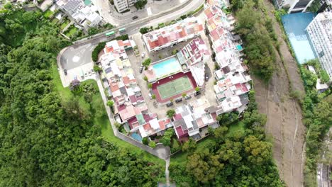 Classic-Temple-in-Hong-Kong,-surrounded-by-lush-green-mountain-terrain,-Aerial-view