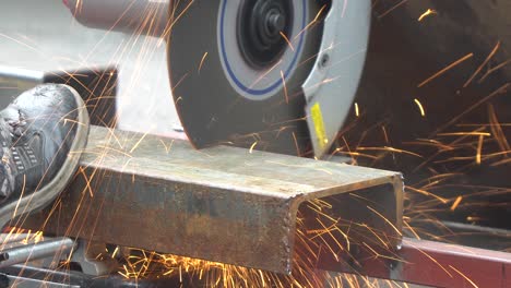 Construction-worker-cutting-steel-C-shape-Channel-frame-with-cutting-circular-saw-machine-close-up-macro