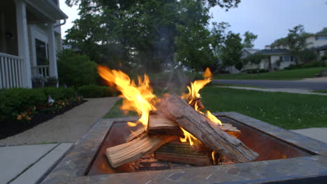 Closeup-of-wood-burning-in-a-fire-pit-on-a-driveway-in-the-suburbs-on-a-nice-summer-evening