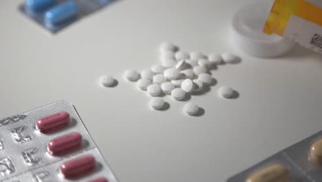 Medical-Capsules-And-Pills-On-The-Table---selective-focus