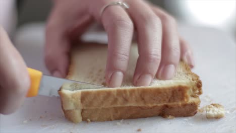 Cutting-the-crust-out-of-bread-slices-with-a-knife