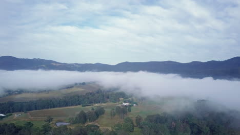 Stunning-aerial-shot-of-Hunter-Valley-with-low-hanging-clouds-covering-landscape