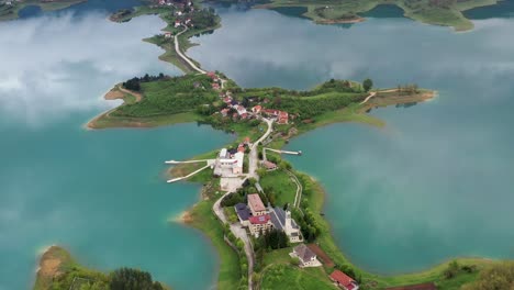 Fly-over-drone-shot-above-the-Šćit-Franciscan-monastery-at-Rama-Lake