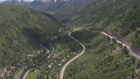 The-aerial-view-pans-up-to-show-a-view-of-beautiful-winding-Colorado-road