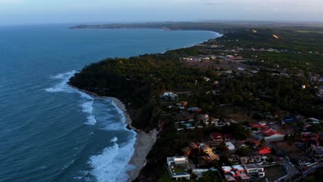 Beautiful-aerial-drone-shot-of-the-tropical-coastline-of-Tibau-do-Sol-near-Pipa,-Brazil-on-a-warm-summer-evening