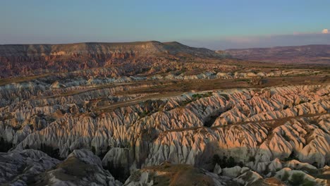 Cappadocia-landscape-with-tuff-stone-formations-after-sunrise,-aerial