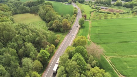 Drone-Aerial-View-of-Germany-Countryside-Road-and-Traffic-Between-Green-Fields-on-Summer-Day