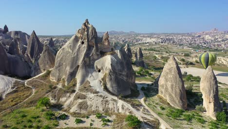 Rock-cut-caves-in-Cappadocia-rock-formations-and-landscape,-aerial-circle-shot