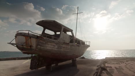 shipwreck-beached-on-sand-near-sea-sunny-day-,-old-ship-ruins-abandoned-vintage-boat-old-memories-sadness