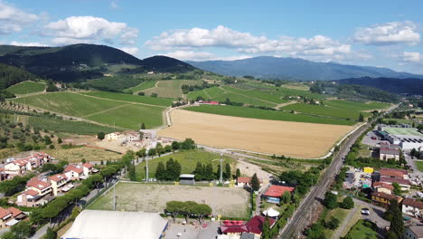 The-Wonderful-Village-With-Green-Fields-Of-Vigna-Plants-Background-With-High-Mountains-Under-The-Bright-Cloudy-Sky--Wide-Shot
