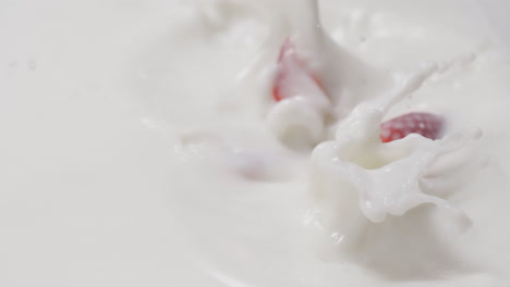 Fresh-strawberries-falling-and-dipping-in-milk