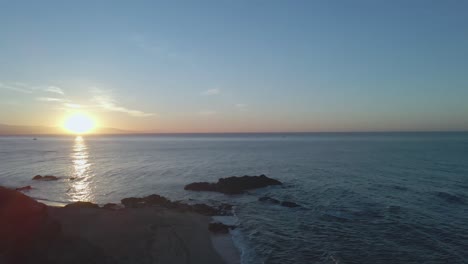 Slow-upward-view-of-sunrise-at-an-empty-beach