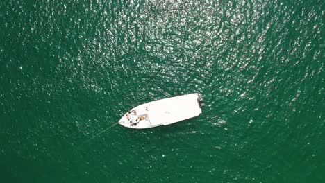 Spnning-reveal-drone-shot-of-boat-on-turquoise-water-in-the-Gulf-of-Oman