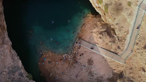 Establishing-aerial-view-of-the-Bimmah-Sinkhole-with-turquoise-water-near-Muscat-in-the-Sultanate-of-Oman