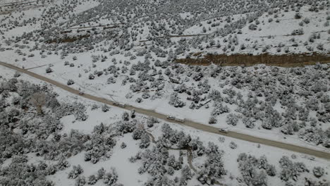 Car-And-Camper-Caravan-Driving-Along-The-Snowy-Landscape-Of-Utah-In-Winter