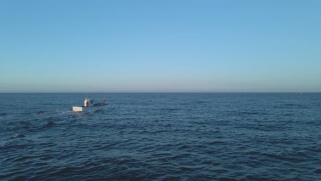 Luftaufnahme,-Fischerboot-Segelt-über-Kleine-Wellen-Im-Offenen-Meer-In-Der-Nähe-Von-Playa-Penon-Del-Cura-Vor-Der-Küste-Spaniens-Gegen-Einen-Klaren-Blauen-Himmel---Mittelmeer