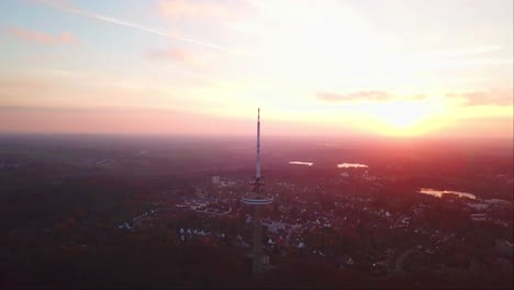 Drone-shot-of-Kiel-Transmission-Tv-Tower-with-a-reddish-evening-sky