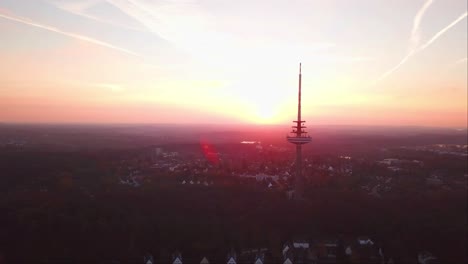 Aerial-shot-of-Kiel-Transmission-Tv-Tower-with-a-reddish-sunset-sky