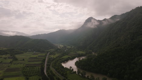 Aerial-View-Of-Potskhovistskali-River,-Countryside-Fields-And-Mountains-In-Akhaltsikhe,-Georgia