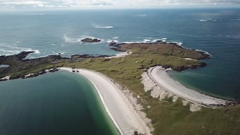 aerial-view-of-clifden-beach-in-Connemara,-blue-water,-sand,-and-grassy-fields
