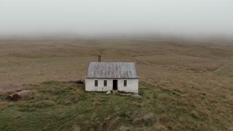 Foggy-scenery-of-abandoned-cabin-with-dead-sheep