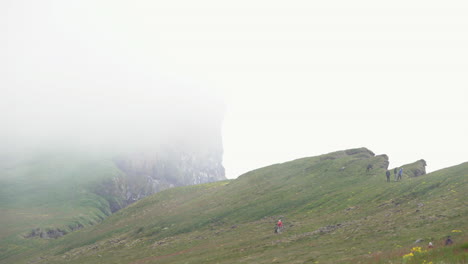 Hikers-on-foggy-Latrabjarg-cliff-in-Westfjords,-Iceland