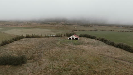Thick-layer-of-fog-above-abandoned-house,-Iceland