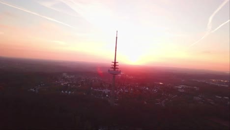 Aerial-drone-shot-of-Kiel-Transmission-Tv-Tower-with-a-reddish-evening-sky