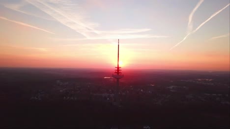 Aerial-view-of-Kiel-Transmission-Tv-Tower-with-a-reddish-evening-sky
