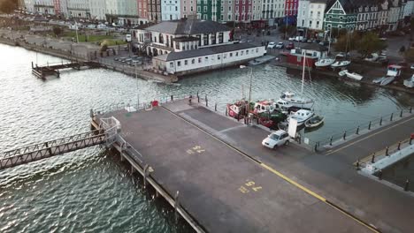 aerial-view-of-pontoon,-boats-and-buildings-in-ireland,-atlantic-ocean-shore