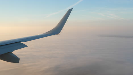 Airplane-Wing-and-Winglet,-Passenger-View-of-Plane-Flying-above-Clouds