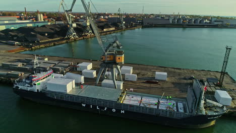 Mobile-Harbour-Crane-Loading-Cargo-On-A-Shipping-Vessel-At-The-Industrial-Port