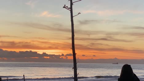 Silhouette-Eines-Riesigen-Sonnenuntergangs-Mit-Frau-Macht-Fotos-Oder-Videos-Bei-Sonnenaufgang-Am-Strand