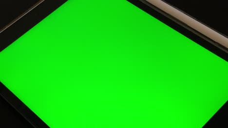 man-watching-a-Green-Screen-Tablet-in-home