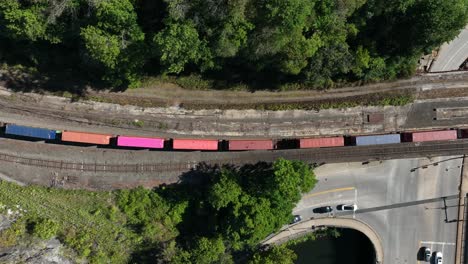 Top-down-aerial-tracking-shot-of-railroad-train-on-tracks