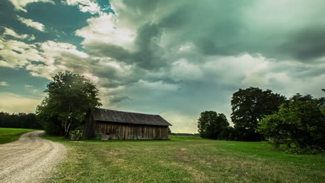 Time-lapse-of-an-eerie-shed-or-warehouse-on-a-daylight-at-an-open-field
