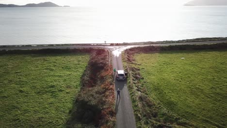 a-car-is-parked-on-a-road-in-ireland-connemara,-scenic-aerial-view-on-the-atlantic-ocean