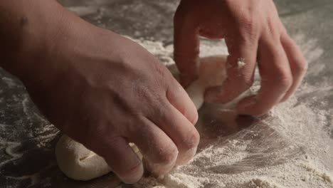 Preparing-dough-in-closeup-on-chef-hands,-kneading-and-stretching-dough-for-khachapuri