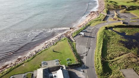 aerial-view,-ocean-shore-in-Ireland,-Connemara,-road-and-grassy-fields
