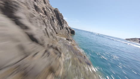 Dynamic-FPV-drone-flying-above-summer-sea-spot-with-many-power-boats,-Spain