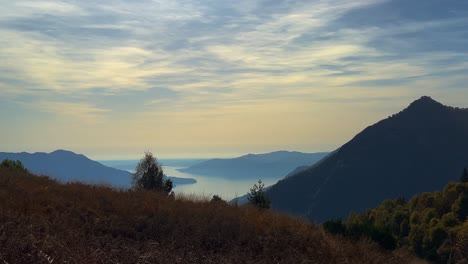 High-angle-panoramic-viewpoint-of-Lake-Maggiore-seen-from-Monte-Carza-mountain,-zoom-in