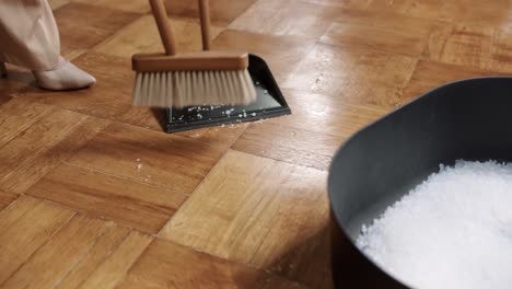 Close-up-of-woman-sweeping-the-floor-in-heels,-domestic-household-maintenance-concept