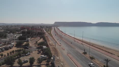 Aerial-View-Marine-Drive-Beside-Beach-Coastline-In-Gwadar-With-Traffic-Going-Past