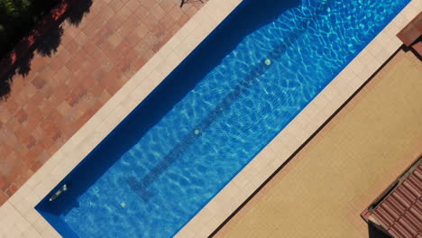 Orbital-aerial-view-over-linear-swimming-pool-in-beautiful-resort