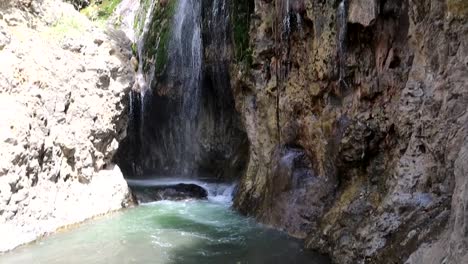 Tilting-downward-shot-of-Engaresero-waterfall-falling-into-the-river-below