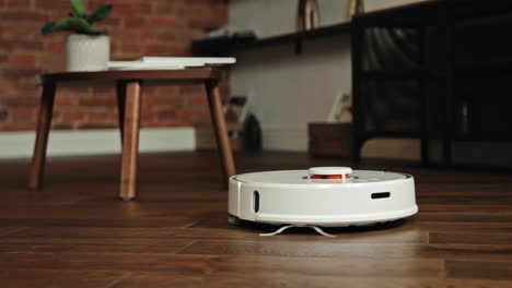 Automatic-robot-vacuum-cleaner-is-tidying-up-at-home,-domestic-household-maintenance-concept